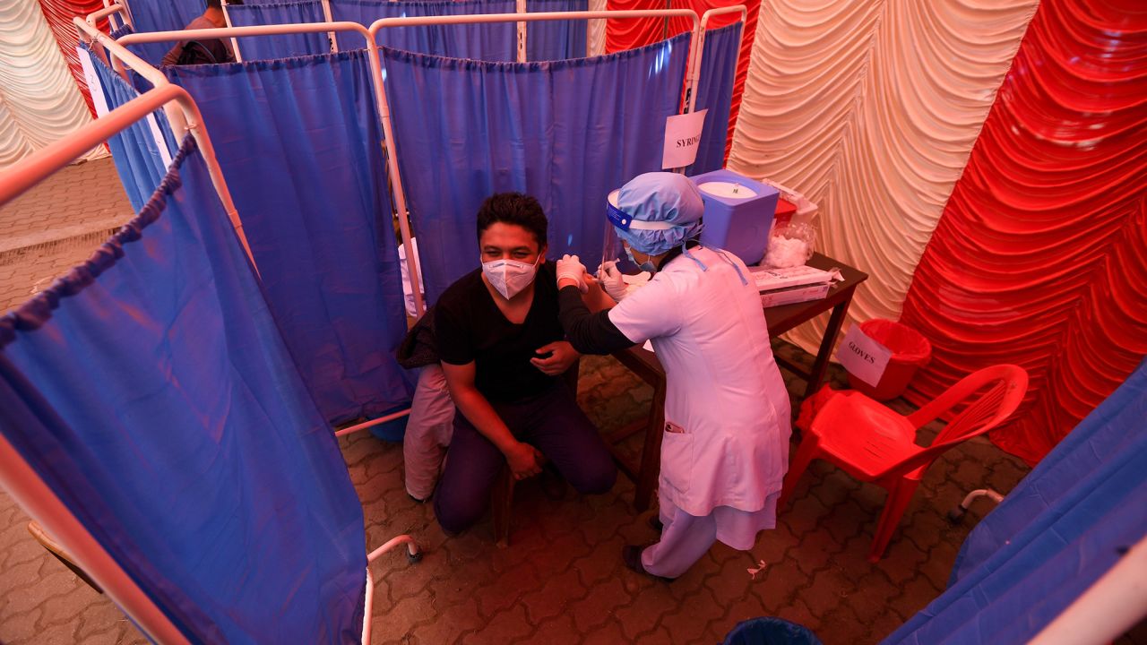 A health worker receives a dose of Covishield, AstraZeneca-Oxford's Covid-19 coronavirus vaccine made by Serum Institute of India, at Patan Hospital near Kathmandu on January 27, 2021. 