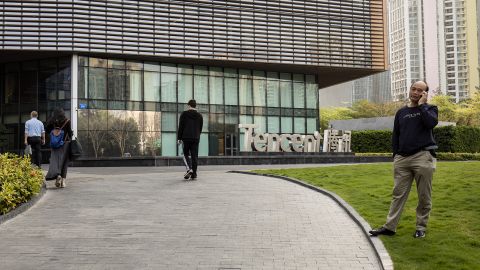 Pedestrians walking past a Tencent sign at the company's headquarters in Shenzhen in March.