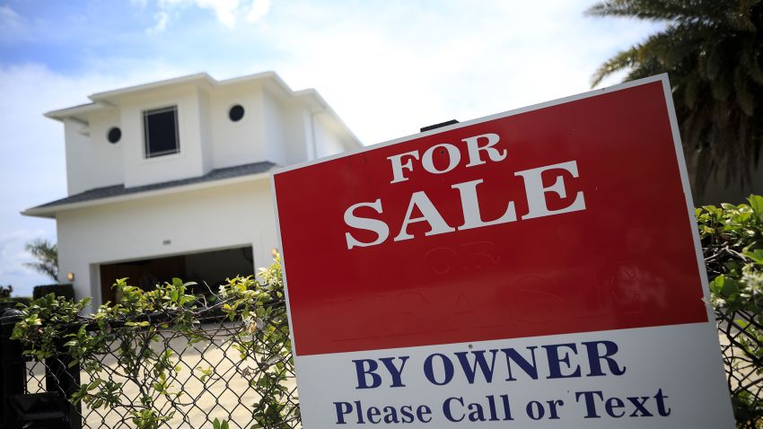 A "For Sale" sign outside a house in West Palm Beach, Florida, U.S., on Wednesday, April 7, 2021. Purchase contracts for single-family houses priced at $10 million or more surged 306% in March from a year earlier, the biggest gain since the pandemic started, appraiser Miller Samuel Inc. and brokerage Douglas Elliman Real Estate said in a report. Photographer: Marco Bello/Bloomberg via Getty Images