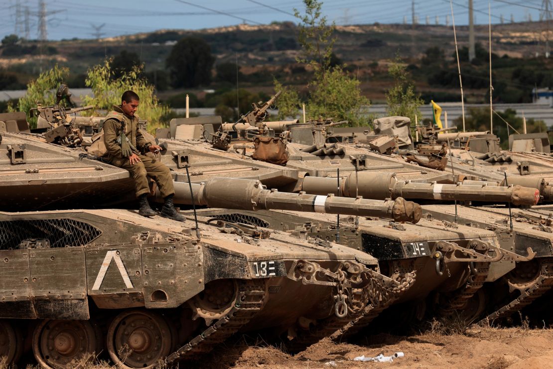 An Israeli soldier sits on top of a tank at a staging ground near the border with Gaza on Friday following the ceasefire agreement.