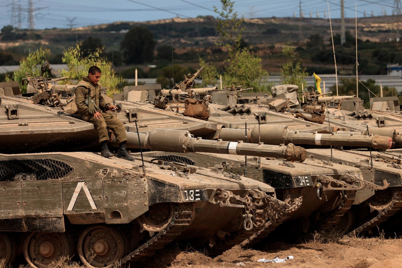 An Israeli soldier sits on top of a tank at a staging ground near the border with Gaza on May 21. It was after a ceasefire agreement was announced.