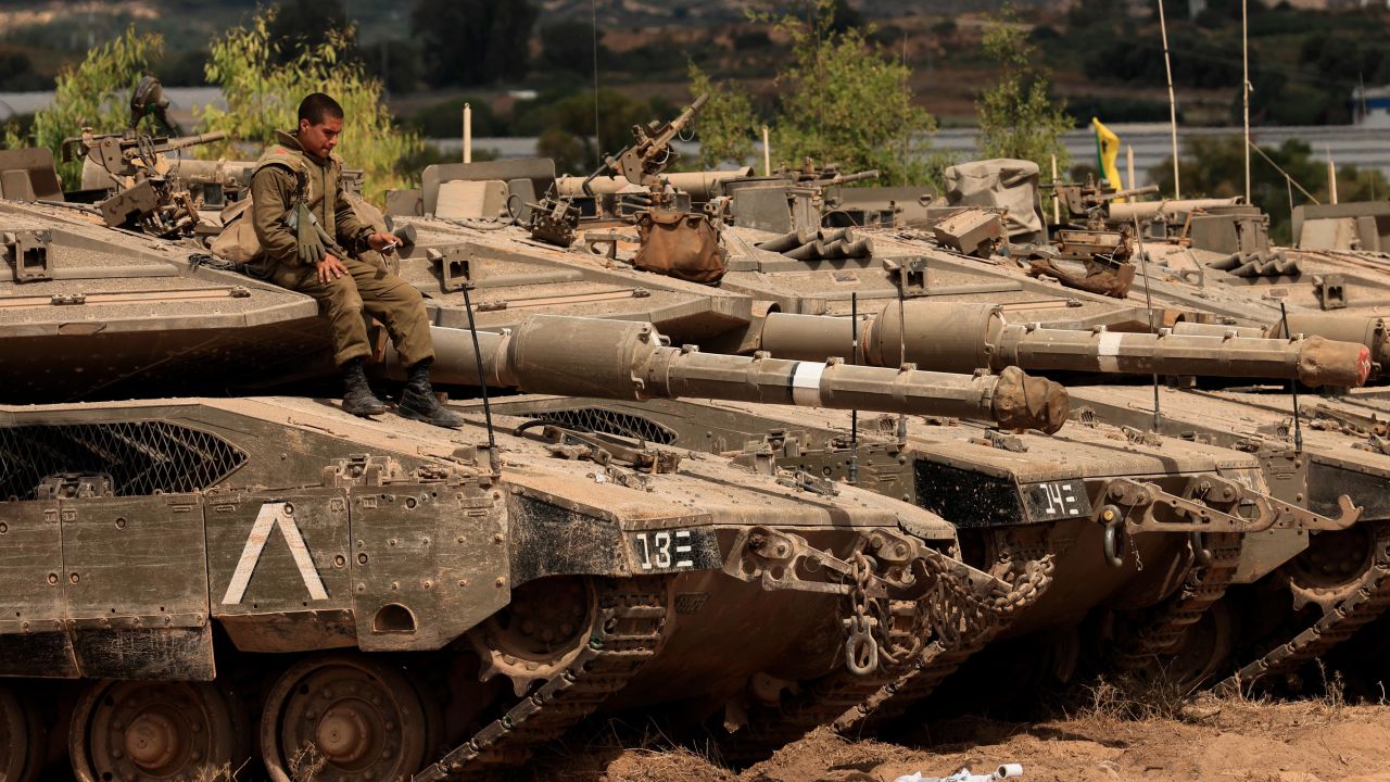 An Israeli soldier sits on top of a tank at a staging ground near the border with Gaza on Friday following the ceasefire agreement.