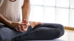 Young latin woman practicing meditation indoors.