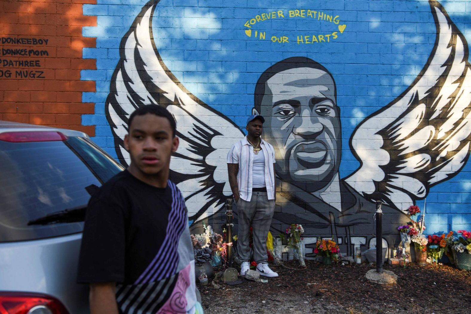 People gather near a Floyd mural in Houston on April 20.