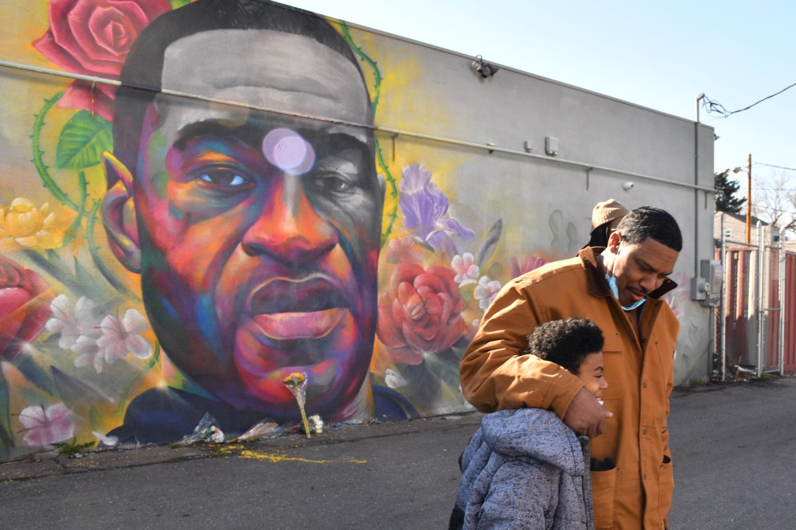 James Stapleton embraces his 11-year-old son, Kareem, after they prayed for Floyd at a mural in Denver on April 20.