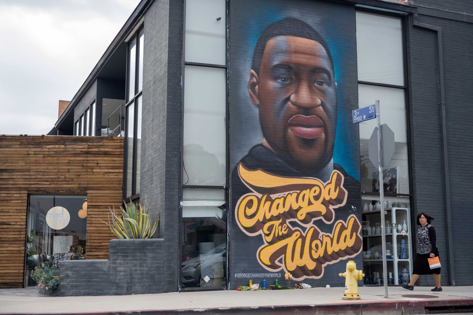 A woman walks past a Floyd mural in Los Angeles on April 21.