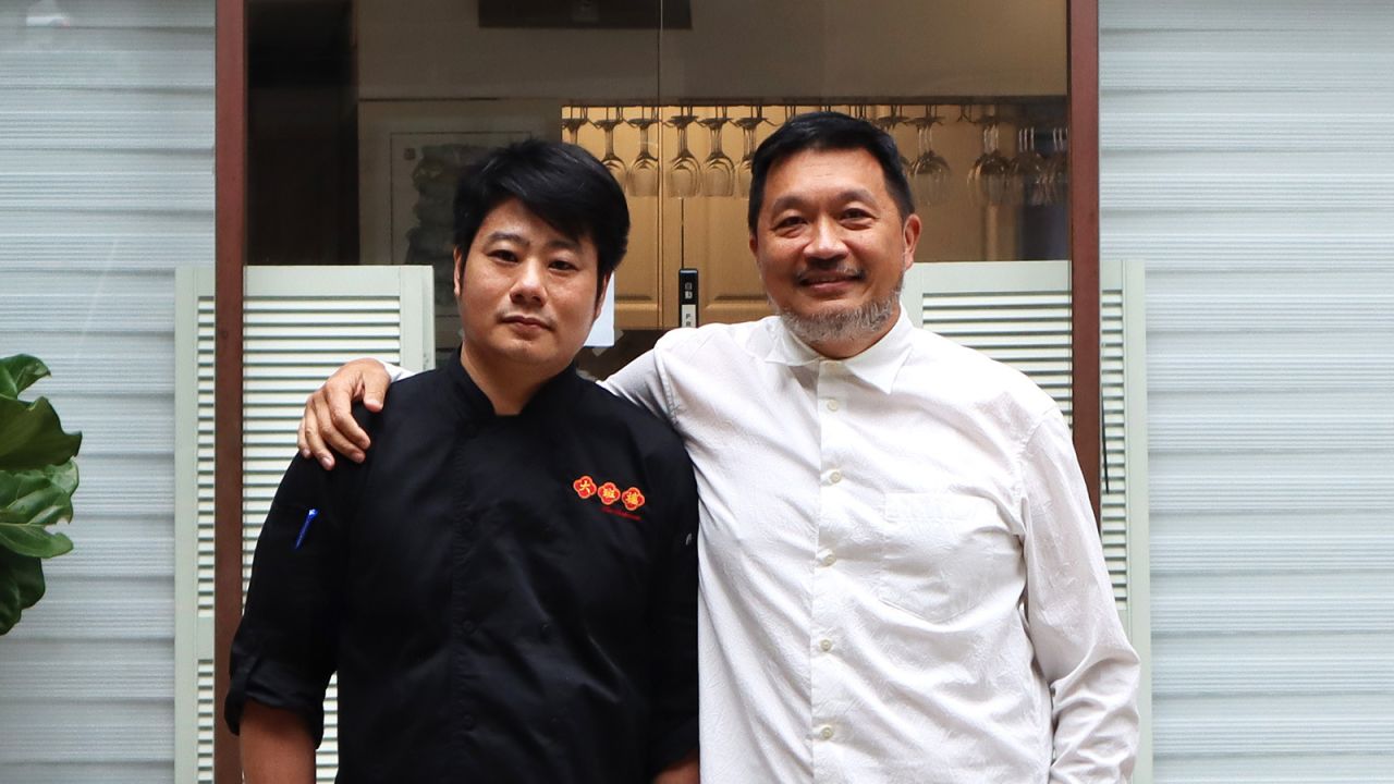 Chef Kwok Keung Tung (left)  stands with The Chairman founder Danny Yip outside the restaurant. 
