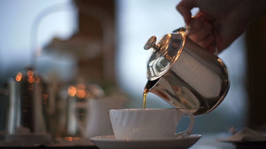 HARROGATE, ENGLAND - FEBRUARY 12: A waitress pours tea at Bettys Tea Room, Harlow Carr on February 12, 2009 in Harrogate, England. The family owned company Taylors of Harrogate have been producing it's blends of teas and coffee since 1886 and serving it's products at the famous and traditional Bettys Tea Shops. Despite recent increases in the price of tea and the surge of coffee shops, the 'cuppa' is proving to be as popular as ever with bookings in Britain's discerning tea rooms being made weeks in advance. Consumption also increases during a recession as tea lovers take solace drinking tea.  (Photo by Christopher Furlong/Getty Images)