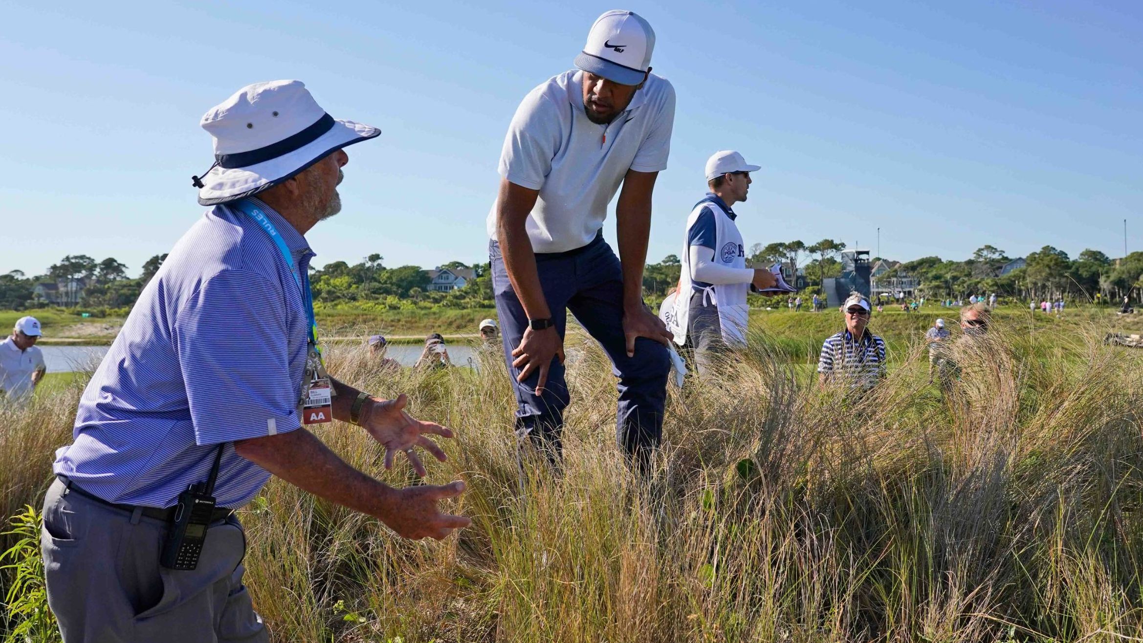 Tony Finau, right, gets a ruling on the 16th hole.