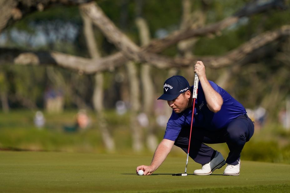 Branden Grace lines up a putt on the third hole.