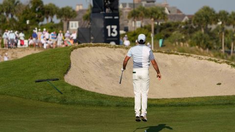 Jason Day jumps up to see over a bunker before taking his shot on the 13th hole.