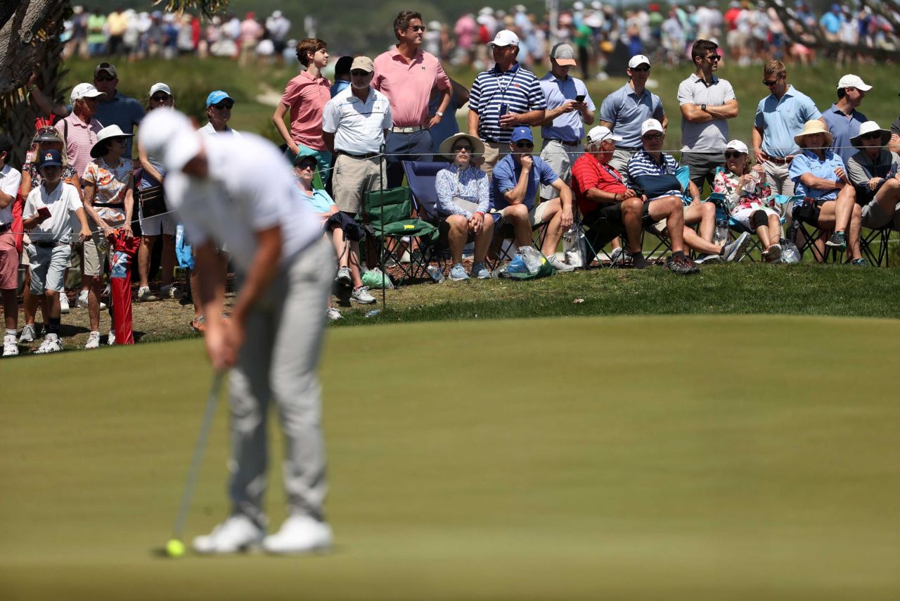 Fans watch a golfer play the seventh green during the second round.