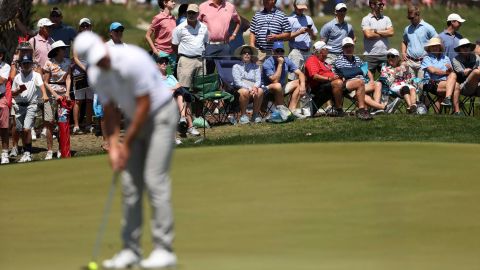 Fans watch a golfer play the seventh green during the second round.