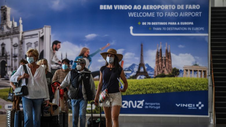 Passengers arrive at Faro airport in Algarve, south of Portugal, on May 17, 2021. - British holidaymakers arrived in Portugal as the country hopes to revive its battered tourism industry after lifting travel restrictions that had been imposed to curb Covid-19. Britons are the biggest contingent of tourists in Portugal, a country whose economy relies heavily on foreign visitors. (Photo by PATRICIA DE MELO MOREIRA / AFP) (Photo by PATRICIA DE MELO MOREIRA/AFP via Getty Images)