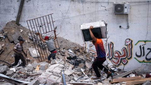 People reclaim materials from a building destroyed by Israeli airstrikes in Gaza City on May 22.