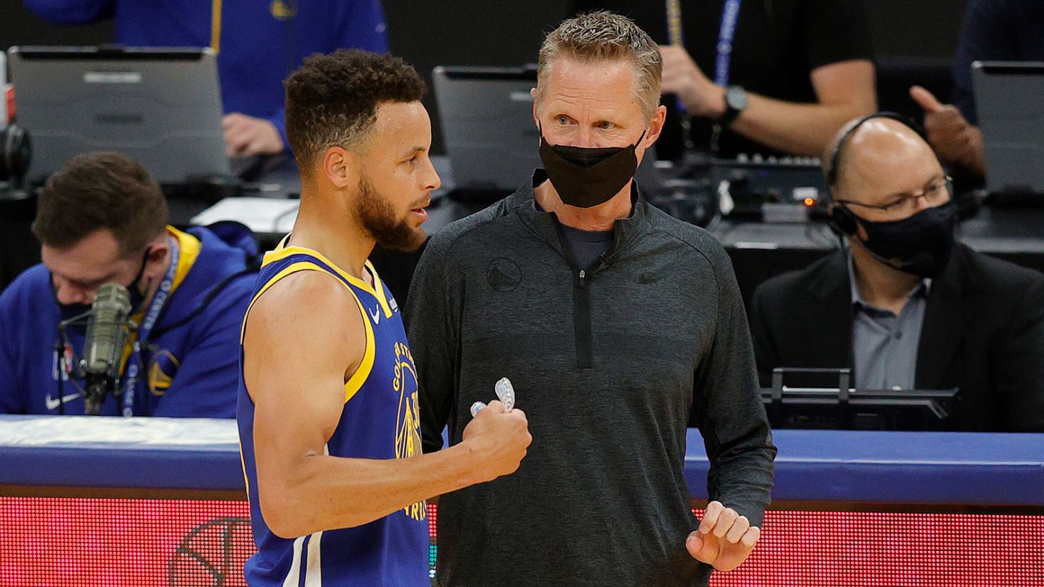 Golden State Warriors head coach Steve Kerr talks to Stephen Curry during a game against the Denver Nuggets at Chase Center in San Francisco on April 12, 2021.