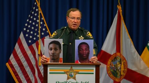 Polk County Sheriff Grady Judd displays mug shots of Chad Berrien, left, and Kevonte' Wilson, who are both facing charges in connection with shooting of a 2-year-old girl by her 3-year-old brother.