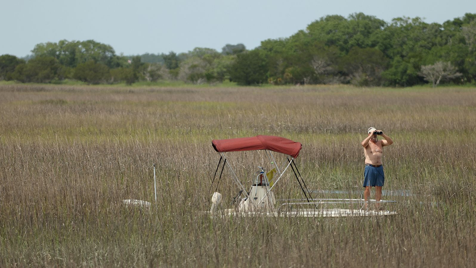 A fan watches from a boat near the fourth hole of the course on Kiawah Island, South Carolina.