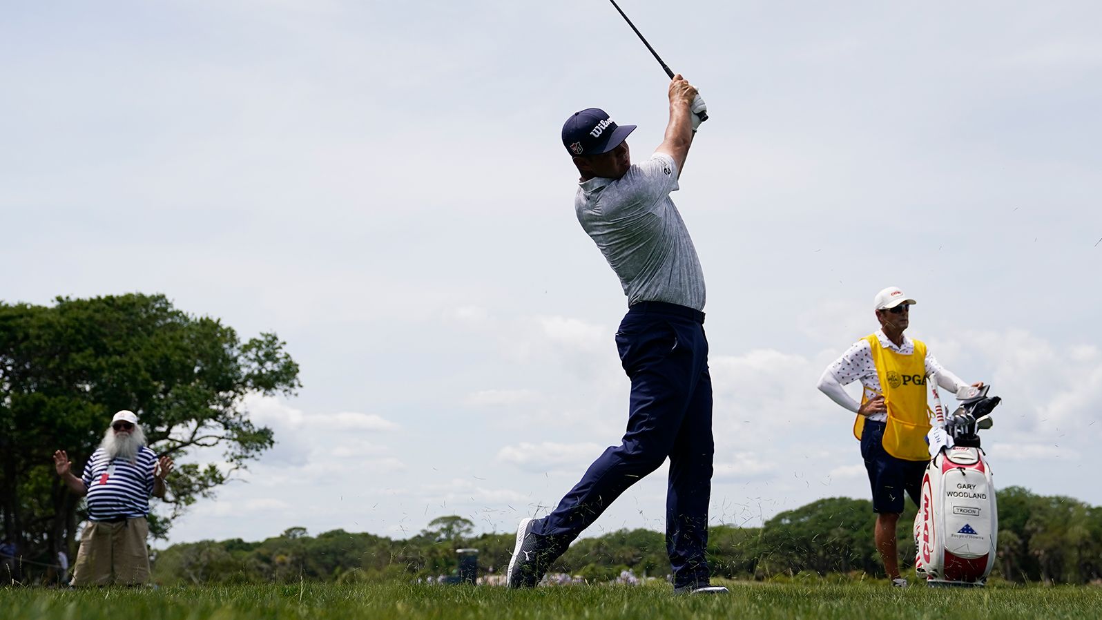 Gary Woodland watches his shot on the second hole.