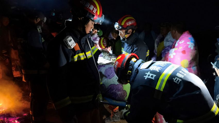 This photo taken on May 22, 2021 shows rescuers assisting people who were competing in a 100-kilometre cross-country mountain race when extreme weather hit the area, leaving at least 20 dead, near the city of Baiyin in China's northwestern Gansu province. - China OUT (Photo by STR / AFP) / China OUT (Photo by STR/AFP via Getty Images)