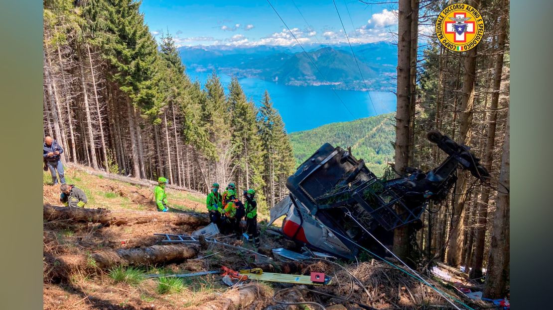 Rescuers work by the wreckage of the cable car on May 23, 2021.