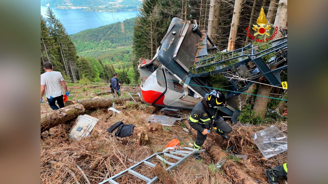 Rescuers work by the wreckage of a cable car after it collapsed near the summit of the Stresa-Mottarone line.