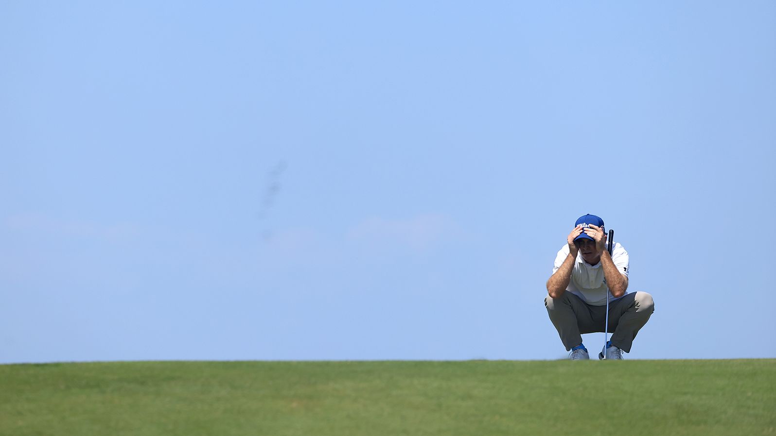 Kevin Streelman lines up a putt on the third green.