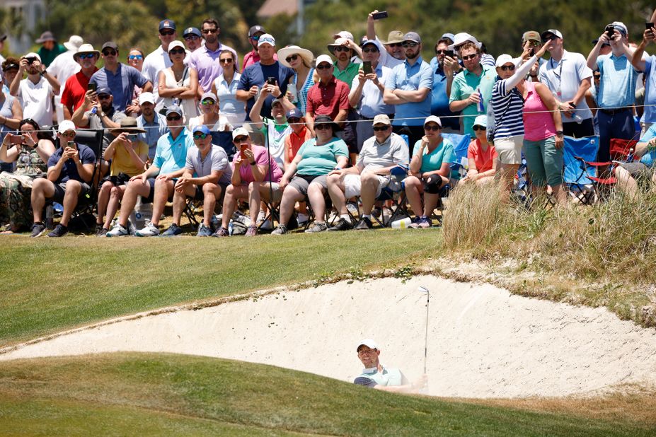 Rory McIlroy plays from a sand area on the 17th green.
