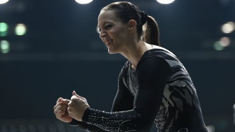 Chellsie Memmel celebrates after competing on the balance beam at the Indiana Convention Center, Indianapolis, Indiana.