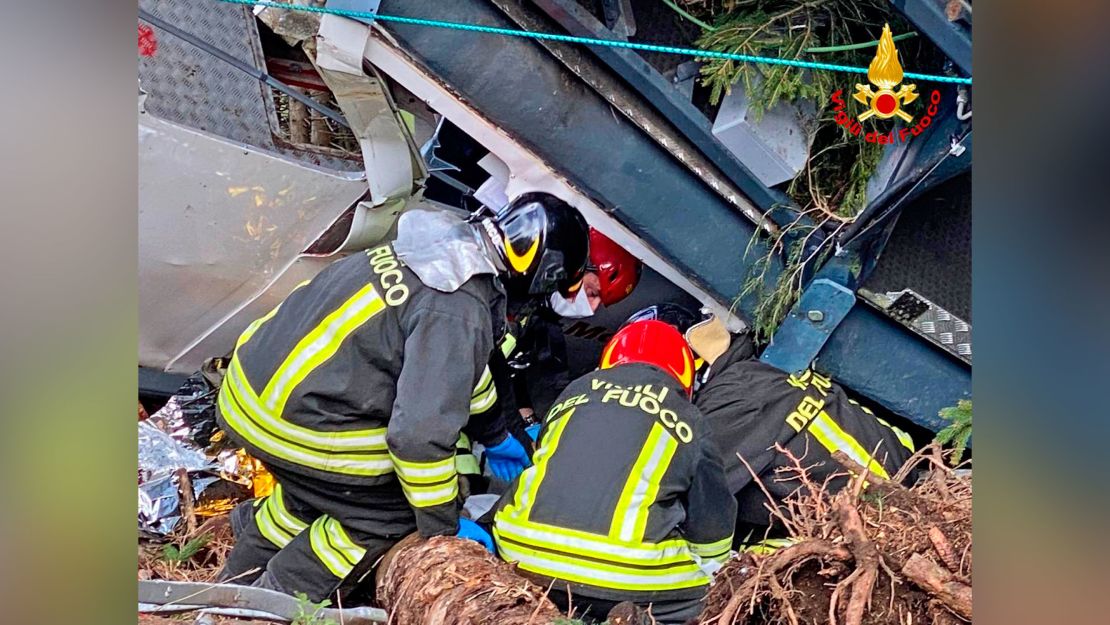 Rescuers work by the wreckage of a cable car after it collapsed near the summit of the Stresa-Mottarone line in the Piedmont region, northern Italy, Sunday, May 23, 2021.