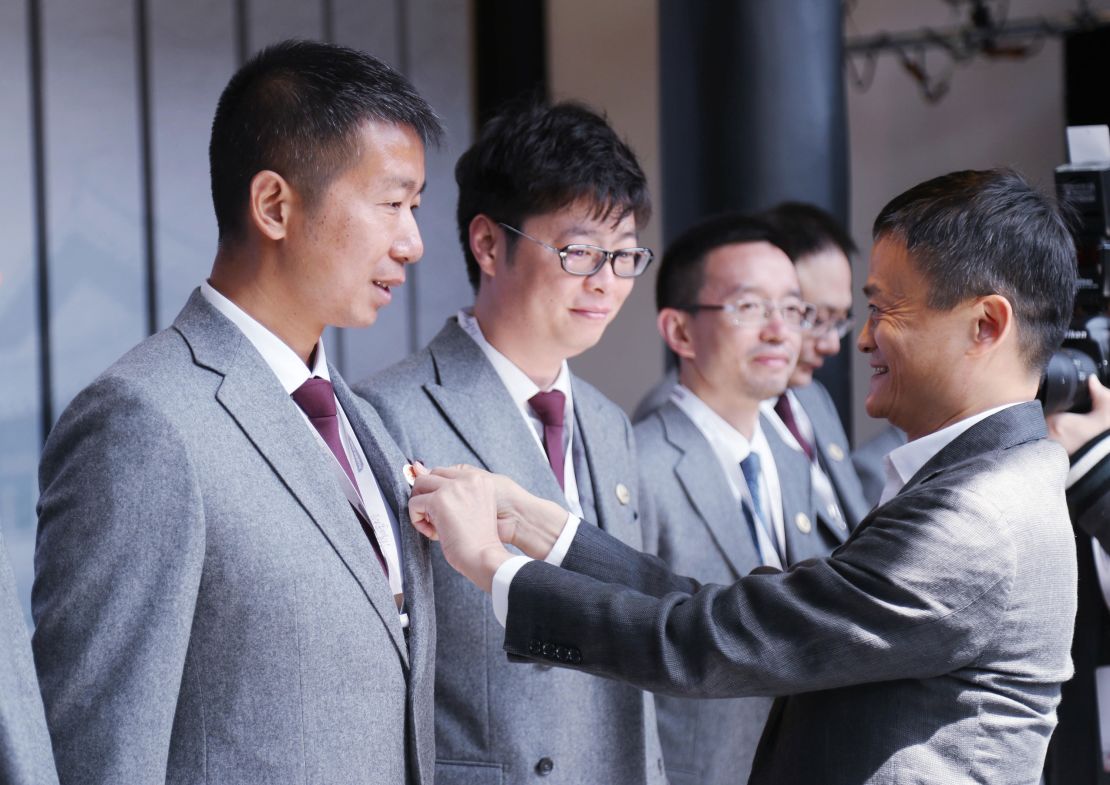 Jack Ma, founder of Chinese e-commerce giant Alibaba Group, puts a school badge on a student during the 3rd school opening ceremony at Hupan in 2017.