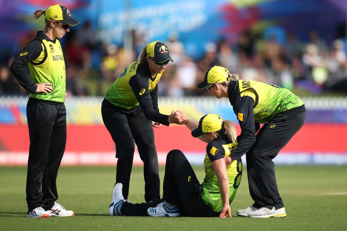 Perry is helped to her feet during the Cricket World Cup match between Australia and New Zealand in Melbourne last year.