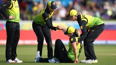 Perry is helped to her feet during the Cricket World Cup match between Australia and New Zealand in Melbourne last year.
