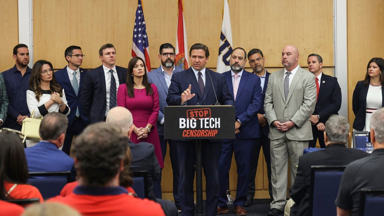 Florida Gov. Ron DeSantis, center, gives his opening remarks flanked by local state delegation members prior to signing legislation that seeks to punish social media platforms that remove conservative ideas from their sites, inside Florida International University's MARC building in Miami on Monday, May 24, 2021. (Carl Juste/Miami Herald via AP)