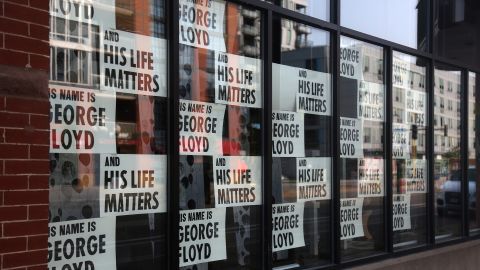 Signs remembering George Floyd are displayed outside a store in Minneapolis on Sept. 19, 2020.