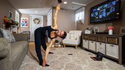Dennis Guerrero, co-owner, and head trainer of Life Outside the Box fitness, leads a virtual exercise class from his living room on November 8th, 2020 in Long Beach, New York. 