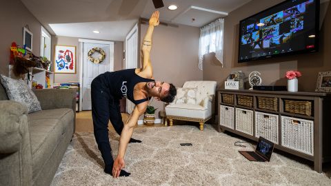 Dennis Guerrero, co-owner and head trainer of fitness platform Life Outside the Box, leads a virtual class from his living room in Long Beach, New York, on November 8, 2020. 