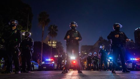Police officers hold a line in front of Los Angeles City Hall during a protest demanding justice for George Floyd, Breonna Taylor and also in solidarity with Portland's protests in July 2020.