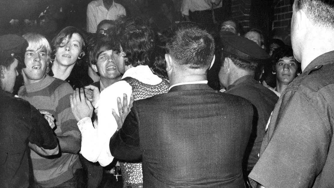 A crowd attempts to impede police arrests outside the Stonewall Inn on Christopher Street in Greenwich Village.