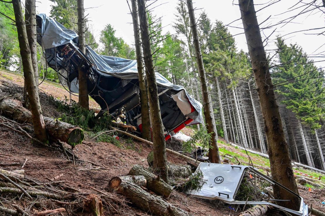 The cabin's wreckage covered with a tarpaulin on Wednesday.