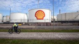 A cyclist passes oil silos at the Royal Dutch Shell Plc Pernis refinery in Rotterdam, Netherlands, on Tuesday, April 27, 2021. Shell reports first quarter earnings on April 29. Photographer: Peter Boer/Bloomberg via Getty Images