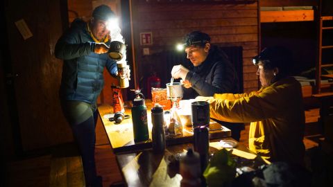 Rusch preparing a meal with her Iceland expedition partners Angus Morton (center) and Chris Burkard (left). 