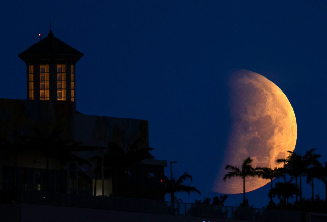 The partially eclipsed moon sets over West Palm Beach, Florida.