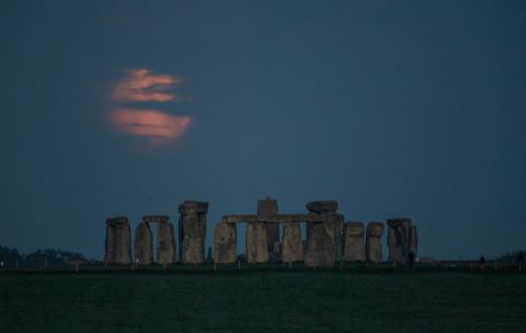 The moon sets over Stonehenge in Amesbury, England.