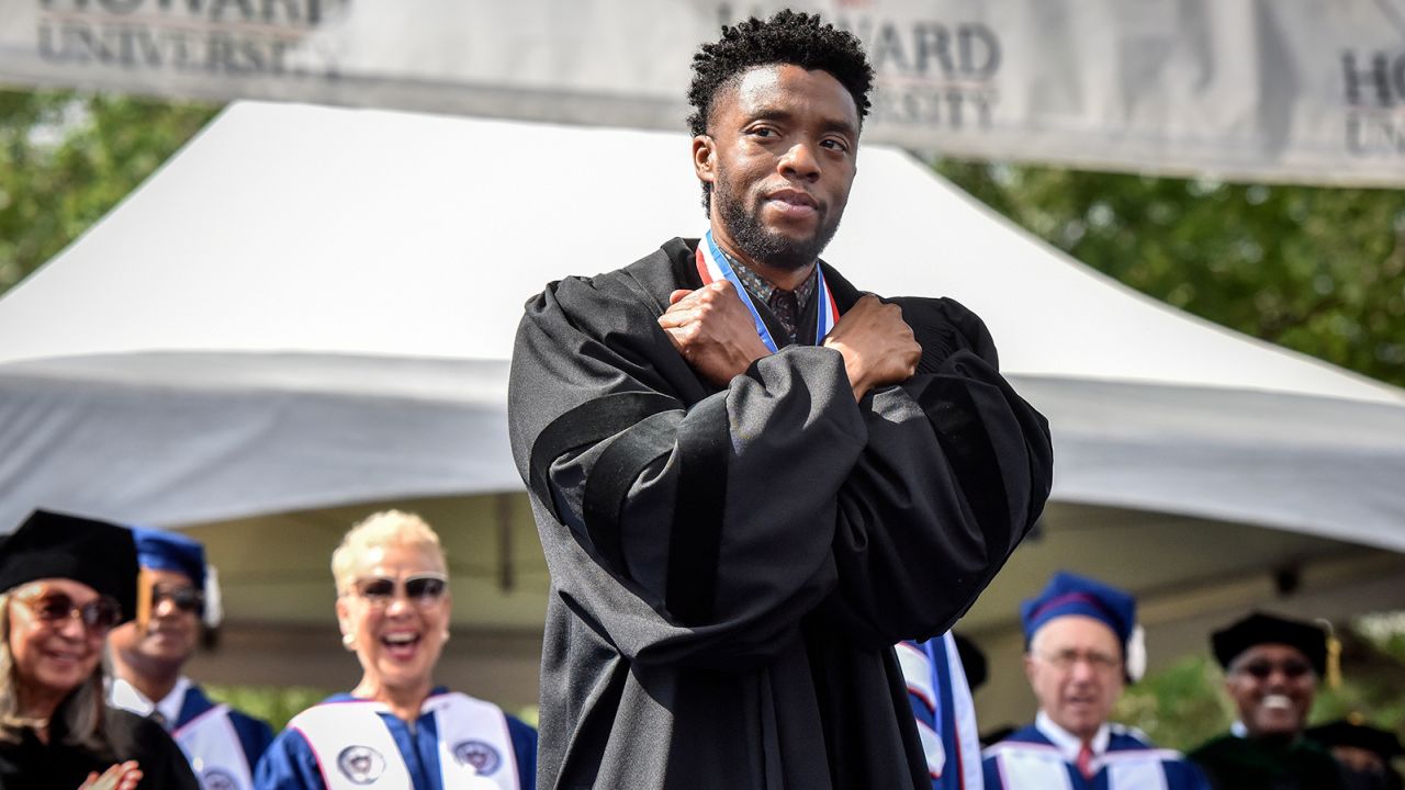 Boseman gives a Wakanda salute during his commencement speech at Howard University on May 12, 2018.