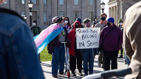 An attendee holds a sign reading "Trans kids belong in sports," at the Transgender Day of Visibility Rally in March in Iowa City, Iowa.