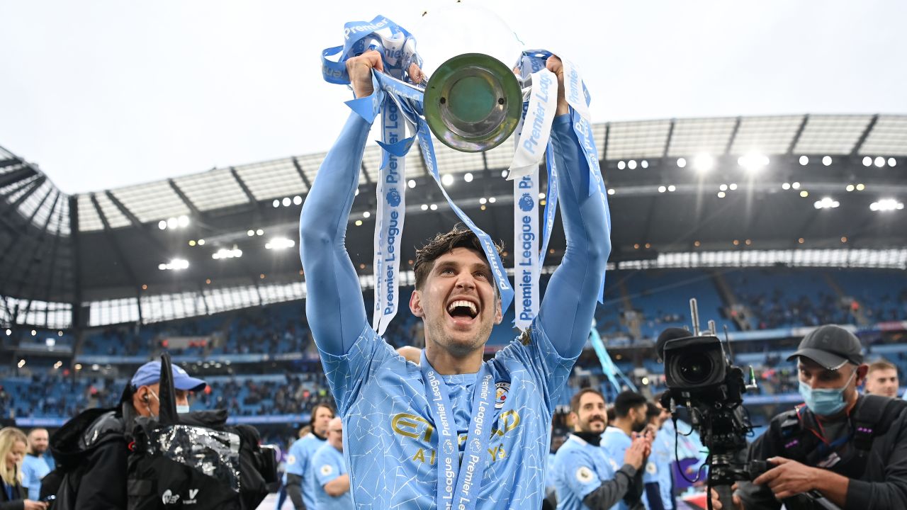 MANCHESTER, ENGLAND - MAY 23: John Stones celebrates with the Premier League Trophy as Manchester City are presented with the Trophy as they win the league following the Premier League match between Manchester City and Everton at Etihad Stadium on May 23, 2021 in Manchester, England. A limited number of fans will be allowed into Premier League stadiums as Coronavirus restrictions begin to ease in the UK. (Photo by Michael Regan/Getty Images)