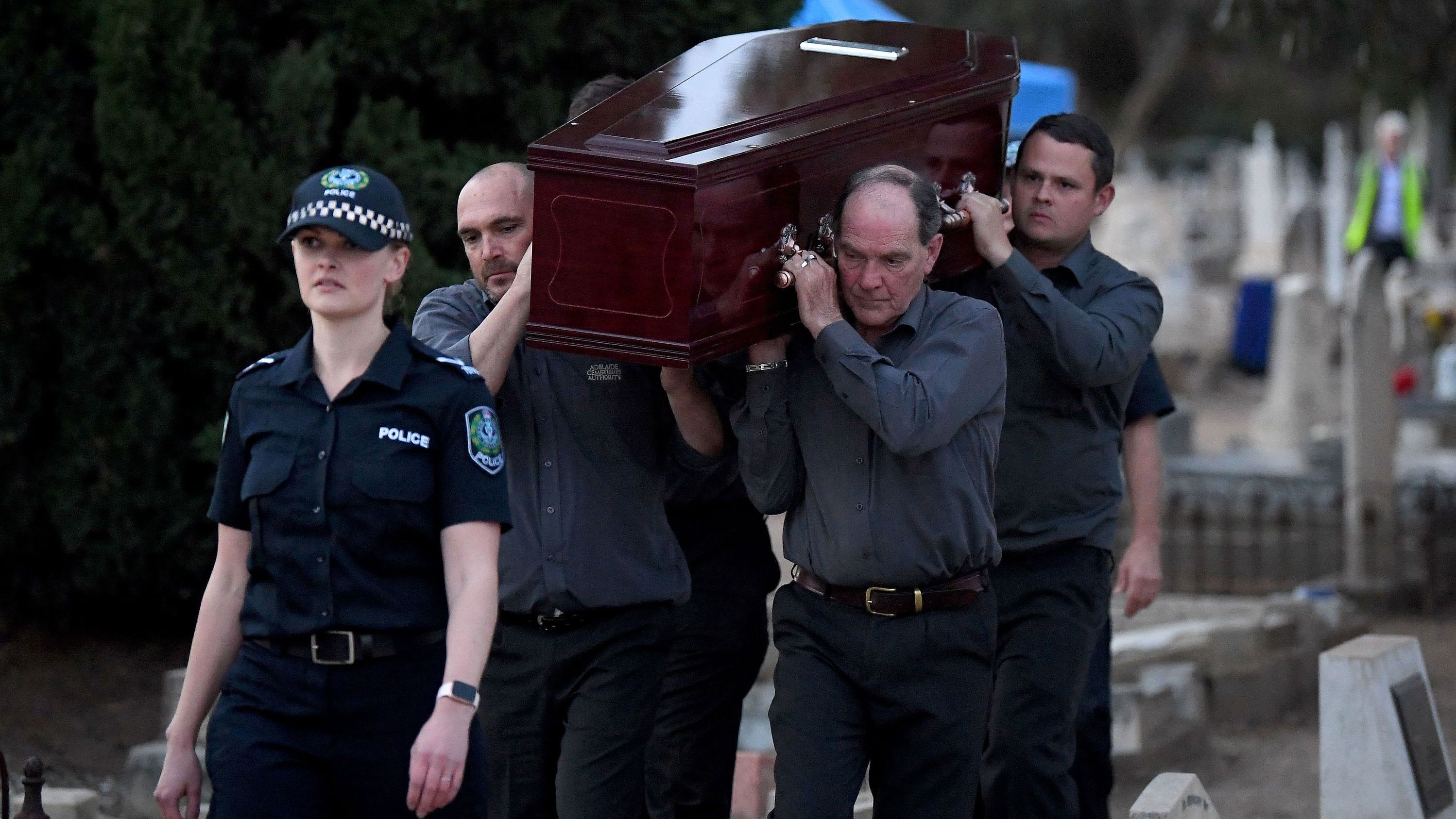Adelaide Cemetery Authority pall bearers carry the body of the exhumed Somerton man, May 19, 2021.
