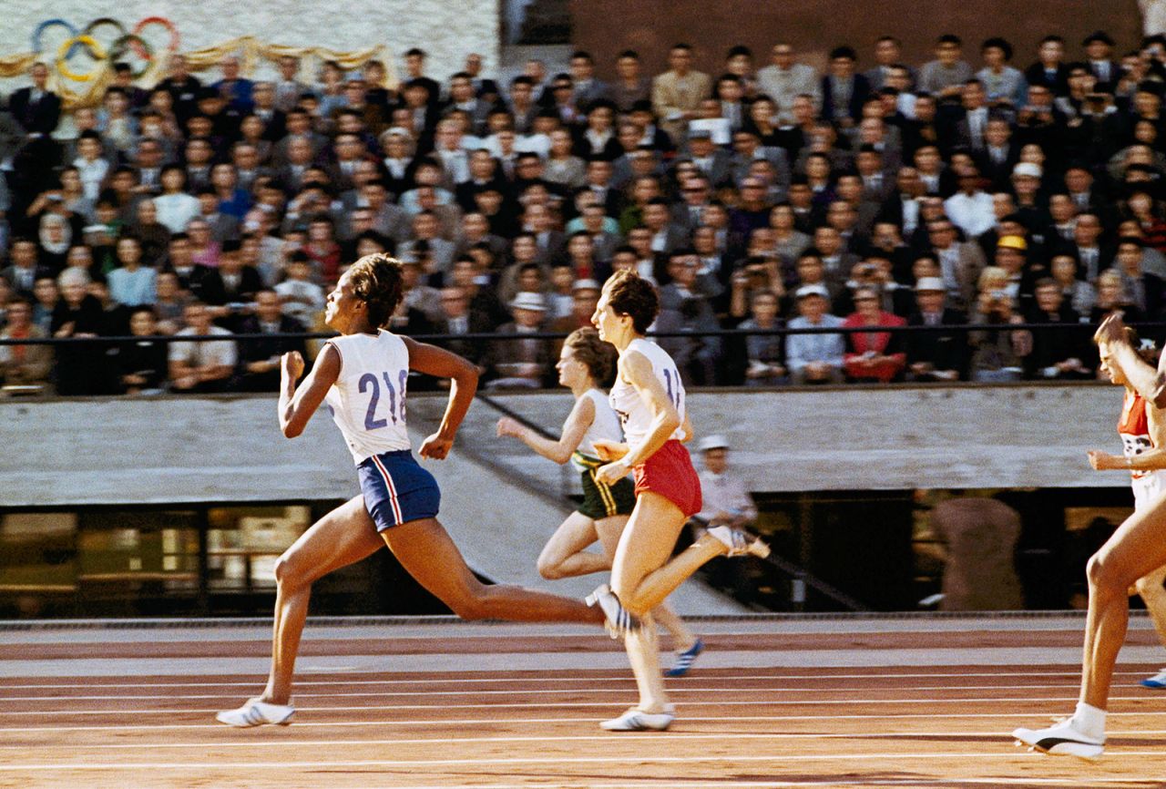 American sprinter Edith McGuire, left, wins the 200-meter dash during the Tokyo Games. She also won silver in the 100 meters.