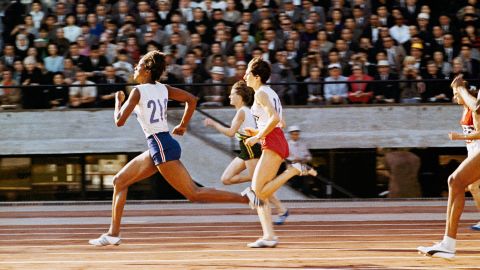 American sprinter Edith McGuire, left, wins the 200-meter dash during the Tokyo Games. She also won silver in the 100 meters.